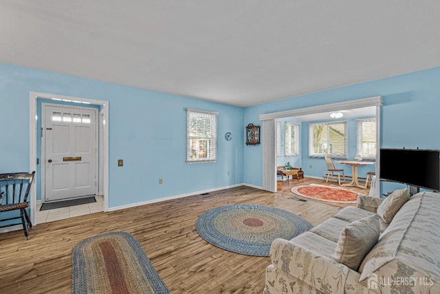 living room with baseboards and wood finished floors