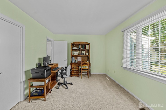 carpeted office space featuring baseboards