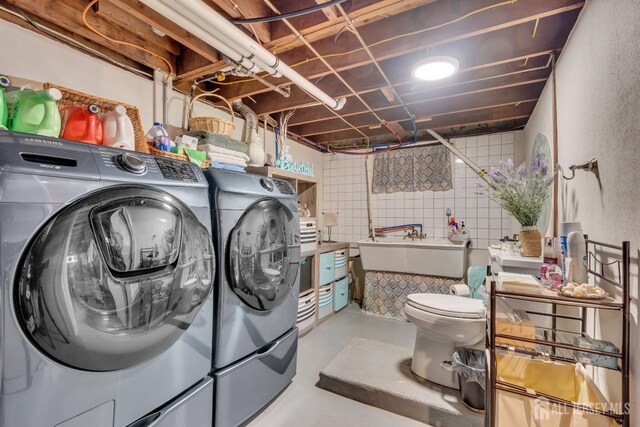 laundry room with sink and separate washer and dryer