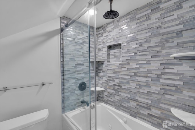 bathroom featuring shower / bath combination with glass door and toilet