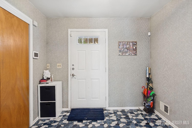 interior space with baseboards and visible vents