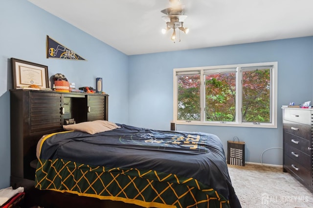 carpeted bedroom featuring baseboards