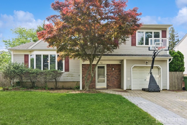view of front of property with an attached garage, decorative driveway, and a front yard