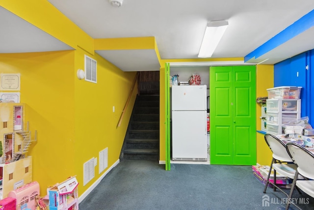 interior space with baseboards, visible vents, and carpet