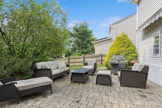 view of patio / terrace featuring an outdoor living space, grilling area, and fence