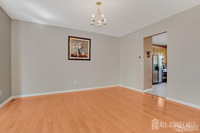 65 Cortland Dr, East Brunswick, NJ 08816 - spare room featuring light wood-type flooring and a chandelier