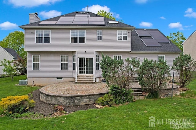65 Cortland Dr, East Brunswick, NJ 08816 - back of property with solar panels, a yard, entry steps, a chimney, and a patio