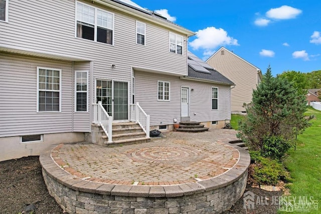 65 Cortland Dr, East Brunswick, NJ 08816 - back of property featuring solar panels, a patio, and entry steps