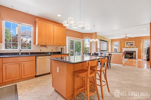 65 Cortland Dr, East Brunswick, NJ 08816 - kitchen with a chandelier, a fireplace, dark countertops, dishwasher, and recessed lighting