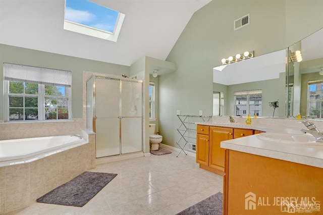 65 Cortland Dr, East Brunswick, NJ 08816 - full bathroom featuring a shower stall, vanity, tile patterned floors, a garden tub, and a skylight