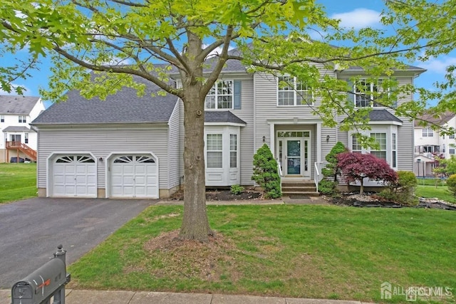 65 Cortland Dr, East Brunswick, NJ 08816 - traditional home featuring driveway, an attached garage, a front lawn, and a shingled roof