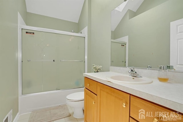 65 Cortland Dr, East Brunswick, NJ 08816 - bathroom with a skylight, vaulted ceiling, vanity, tile patterned flooring, and combined bath / shower with glass door