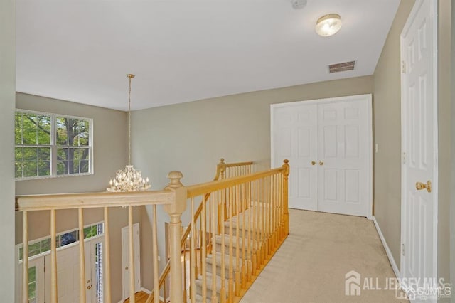 65 Cortland Dr, East Brunswick, NJ 08816 - hallway featuring a chandelier, an upstairs landing, and carpet floors