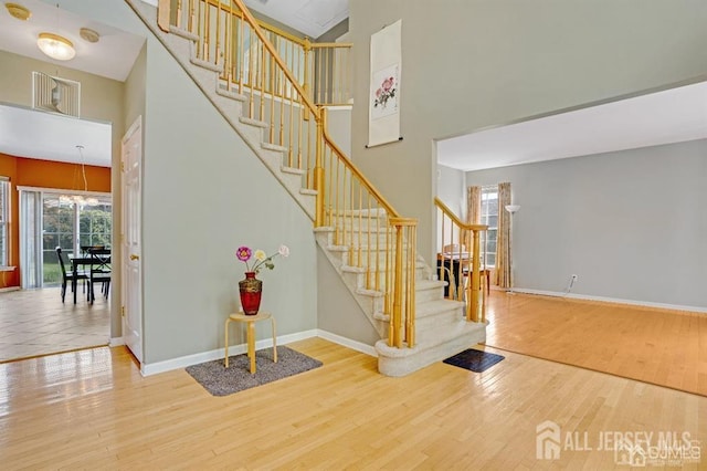 65 Cortland Dr, East Brunswick, NJ 08816 - stairway featuring wood finished floors and a high ceiling
