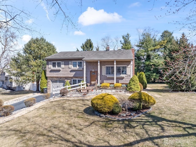 split foyer home with driveway, a garage, and a chimney