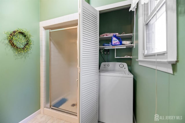 washroom with baseboards, laundry area, and washer / clothes dryer