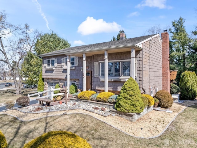 view of front of home featuring a chimney and a garage