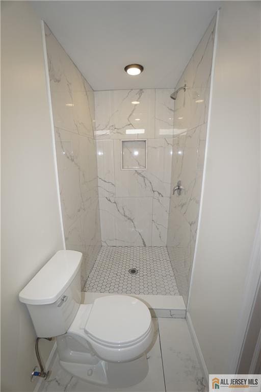 full bath with a marble finish shower, marble finish floor, toilet, and baseboards