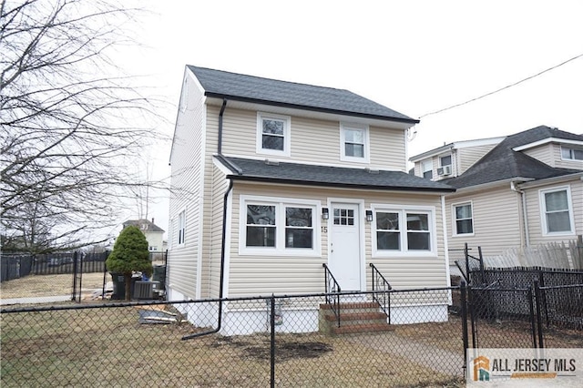 15 Wedgewood Ave, Woodbridge Proper, NJ 07095 - view of front of house featuring entry steps, central AC unit, fence private yard, and roof with shingles