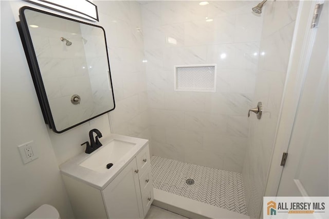 full bath featuring vanity and a shower stall