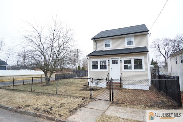 view of front of house with a fenced front yard and a gate