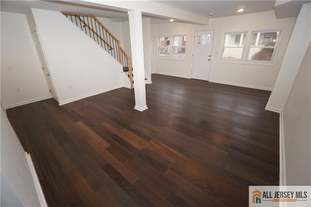 below grade area featuring stairs, recessed lighting, dark wood-style floors, and baseboards