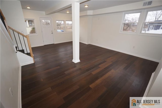 basement featuring visible vents, dark wood-type flooring, recessed lighting, stairway, and baseboards