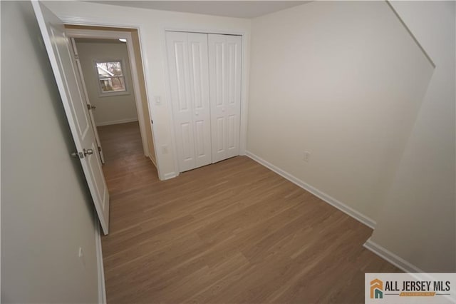15 Wedgewood Ave, Woodbridge Proper, NJ 07095 - unfurnished bedroom featuring wood finished floors, baseboards, and a closet