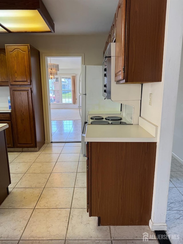 93 Mansfield Ave, Manchester, NJ 08579 - kitchen featuring light countertops, white range with electric cooktop, light tile patterned flooring, and stainless steel microwave