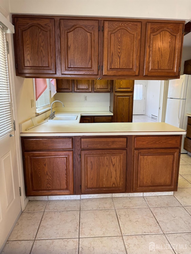 93 Mansfield Ave, Manchester, NJ 08579 - kitchen with freestanding refrigerator, light countertops, a peninsula, and plenty of natural light