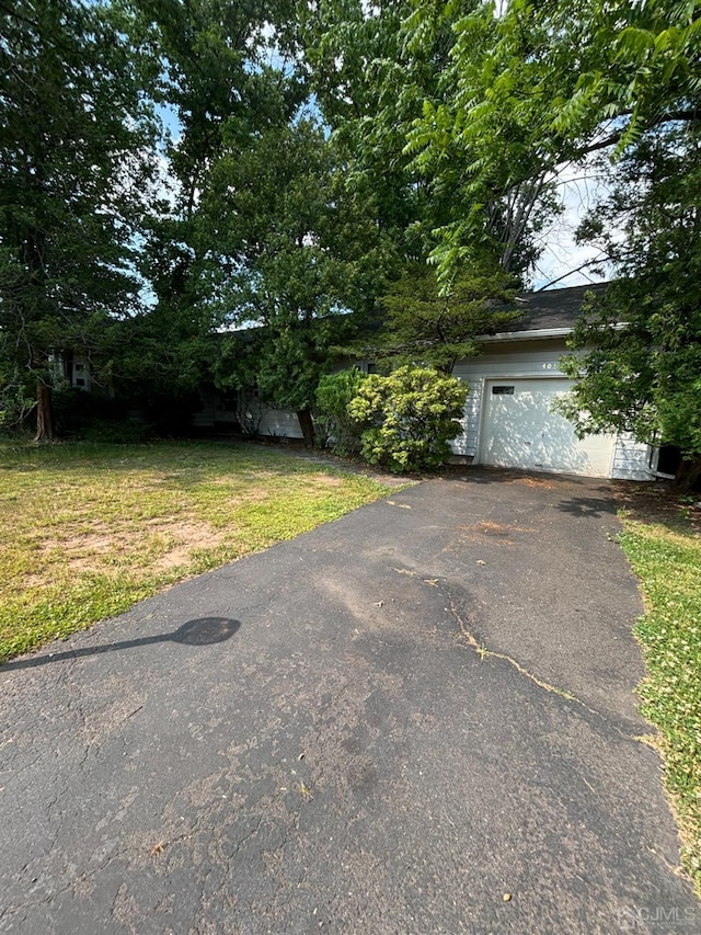 view of front of property with a garage and a front lawn