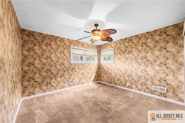 unfurnished room with a ceiling fan, carpet floors, and baseboards