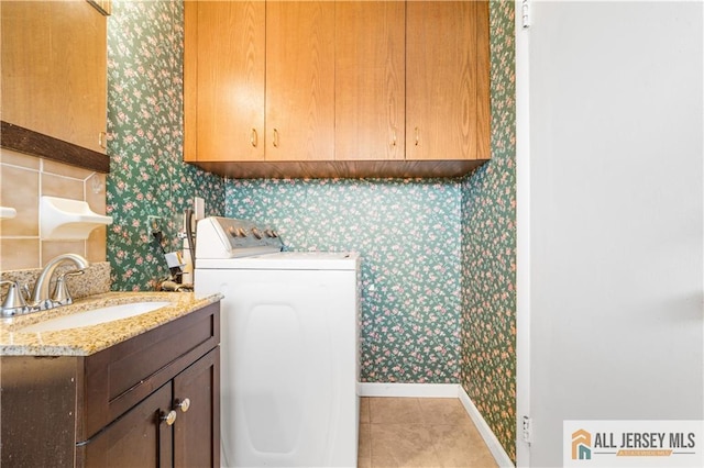 laundry room featuring washer / dryer, wallpapered walls, baseboards, a sink, and light tile patterned floors