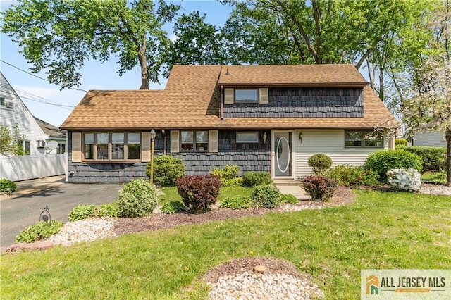 view of front of home featuring roof with shingles