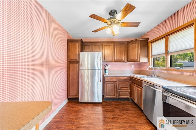 8 Farmbrook Dr, Old Bridge, NJ 08857 - kitchen with appliances with stainless steel finishes, wallpapered walls, dark wood finished floors, light countertops, and a ceiling fan