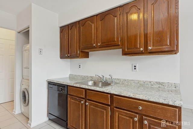 kitchen with sink, light tile patterned floors, dishwasher, stacked washing maching and dryer, and light stone countertops