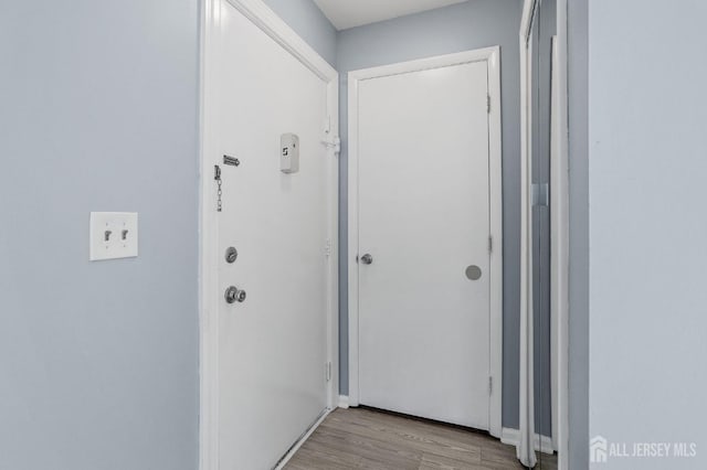 doorway with light wood-type flooring