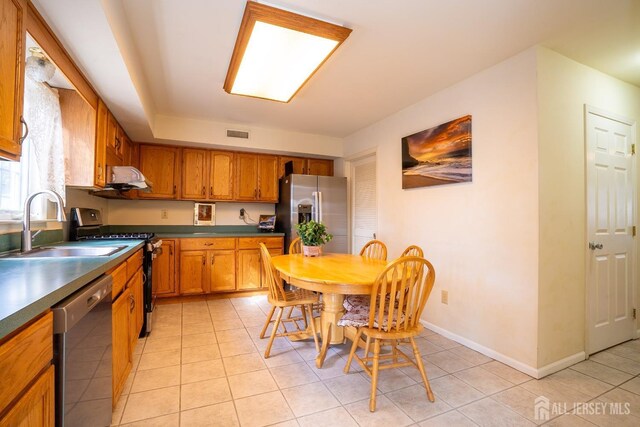 kitchen with light tile patterned floors, sink, and appliances with stainless steel finishes