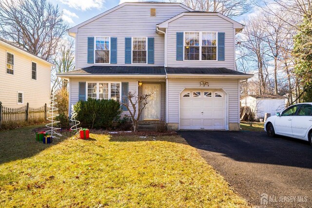 view of front of property with a garage and a front lawn