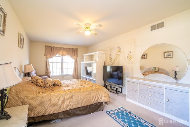 bedroom with light carpet and ceiling fan