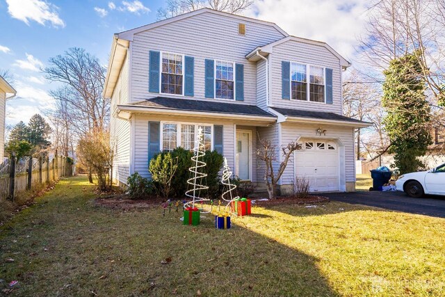 view of front property featuring a front lawn and a garage