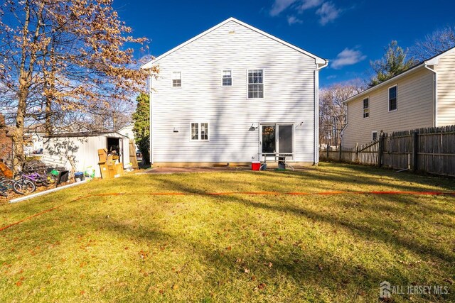 back of house featuring a lawn