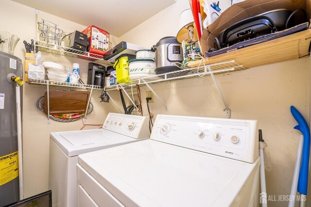 laundry area featuring water heater and washing machine and dryer