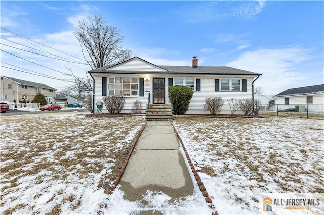 view of front of home with fence and a chimney