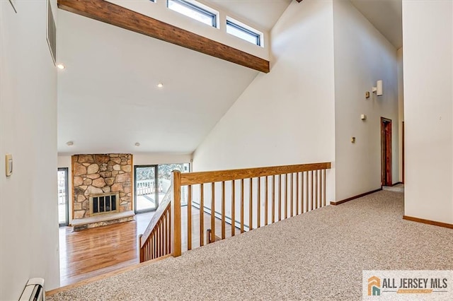 hallway featuring baseboards, carpet floors, high vaulted ceiling, beamed ceiling, and baseboard heating