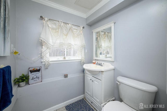 bathroom with toilet, vanity, and crown molding