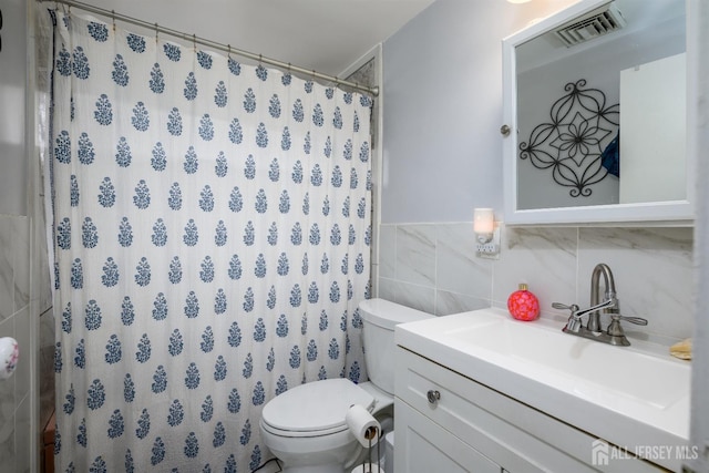 full bathroom featuring toilet, tile walls, visible vents, curtained shower, and vanity