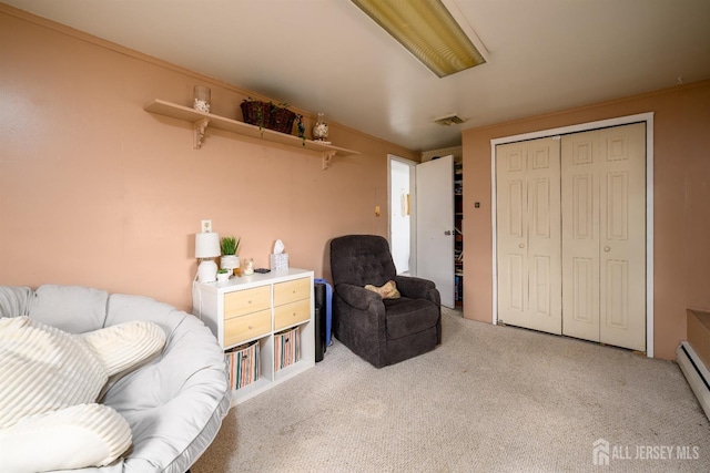 sitting room with a baseboard radiator, visible vents, and light colored carpet