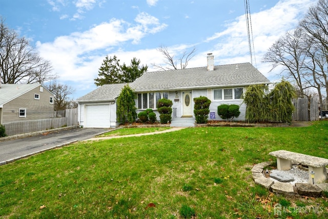 ranch-style home featuring fence, a front lawn, a chimney, and aphalt driveway