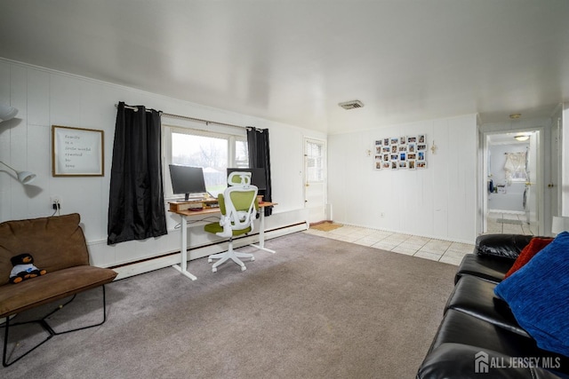carpeted living area with a baseboard heating unit, tile patterned floors, and visible vents